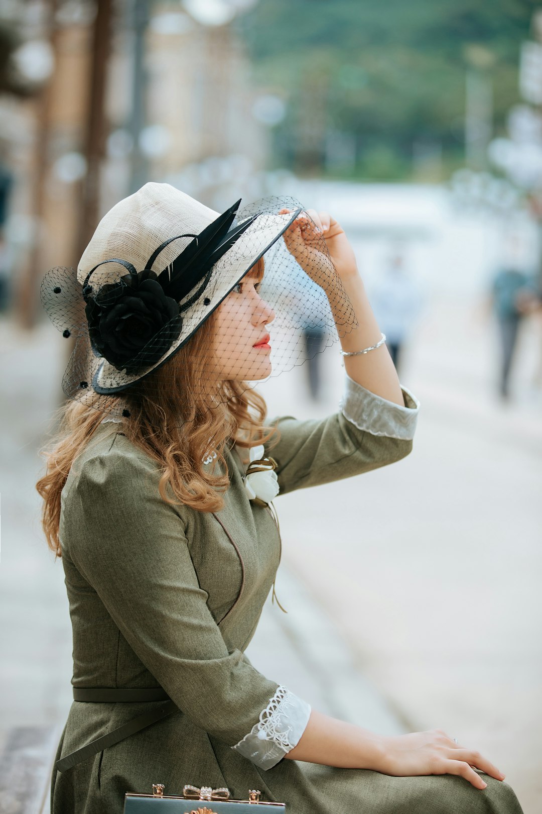 A woman in a vintage hat and dress